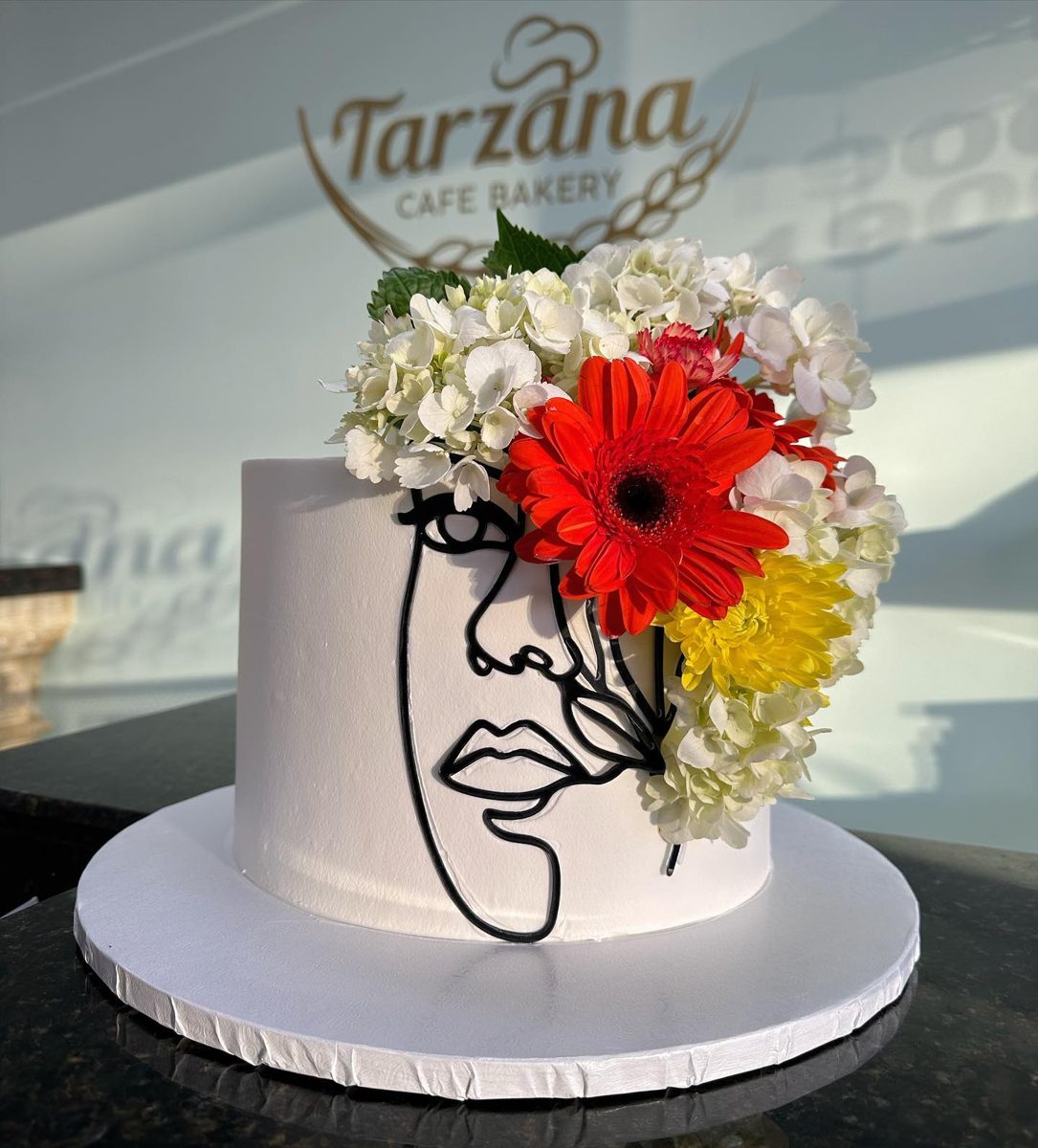 Face Outline Cake With Colorful Flowers from Tarzana Bakery